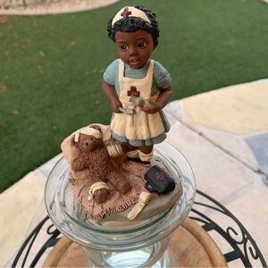 A Little Nurse, Named Merci, is Helping HerTeddy Bear Back to Health as Pictured